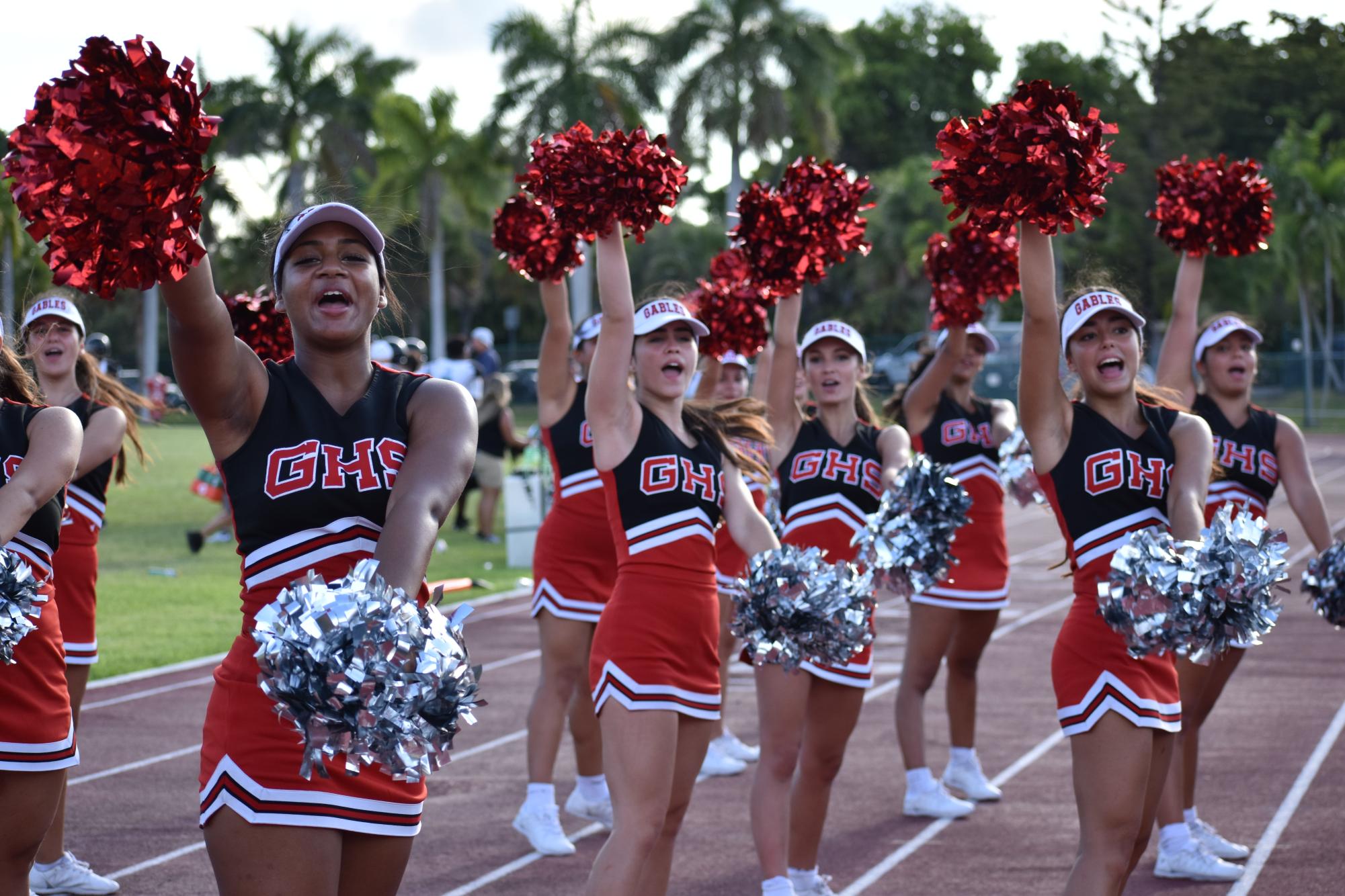 Pouring her heart into the game, co-captain Guzman cheers on the varsity Cavaliers against the Coral Reef Barracudas last year.