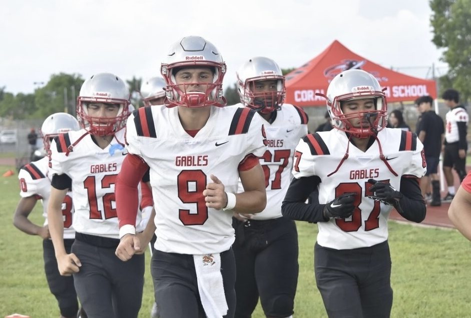 Senior Andreus Rios makes his entrance on the field, alongside his teammates. 