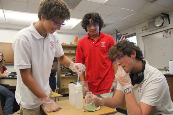 Upon boiling the the hydrochloric acid and tablet mixture, junior Anthony Marrero carefully lets three drops of phenolpthalein, a pH color indicator, flow into the mixture.
