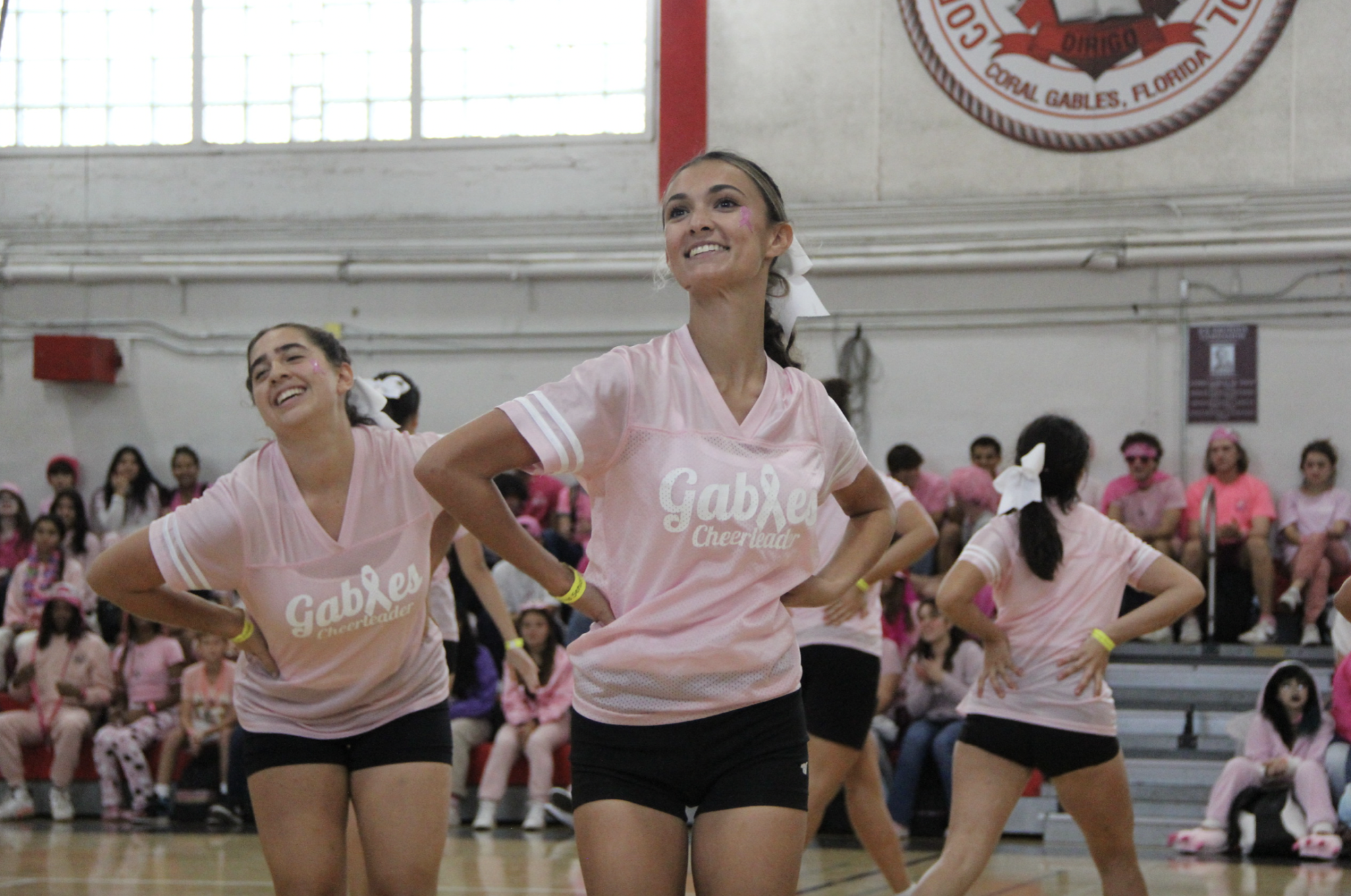 Posing at the pink pep rally last year, Captain Charlee Trowbridge smiles in happiness as she hears the cheers and applauses from the crowd.