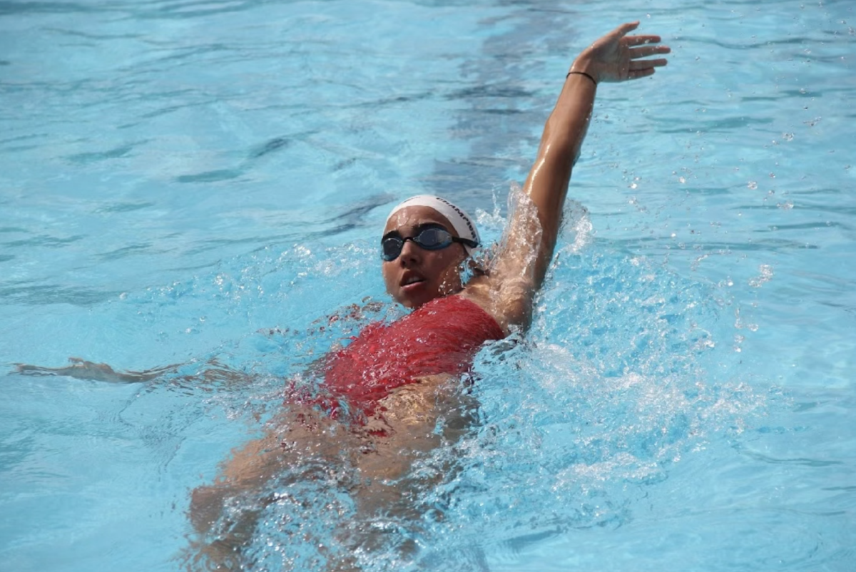 Sophomore Sofia Abril swims backstroke at the second meet of the season, hosted by Ransom Everglades. 