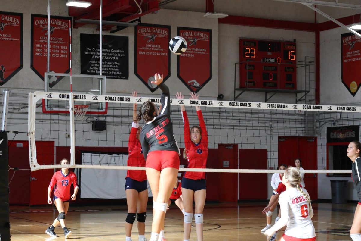 Bianca Benson spikes the ball, scoring the second-to-last point of the set.
