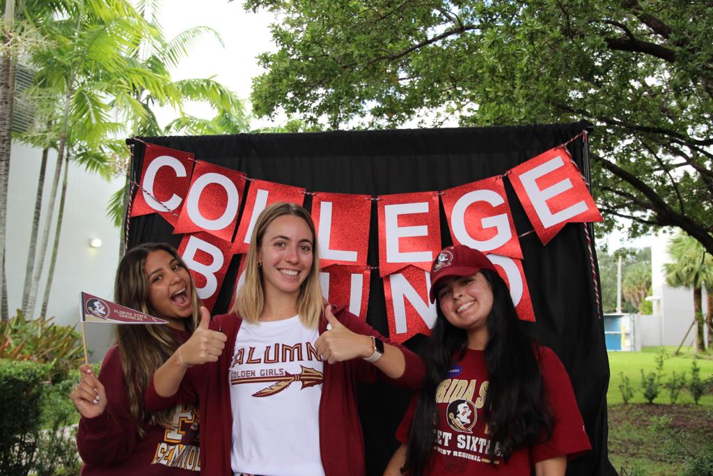 Posing with her students during the 2022-2023 college photo booth, Ms. Sanz reflects on all the lives she touched upon and the paths she helped pave. 