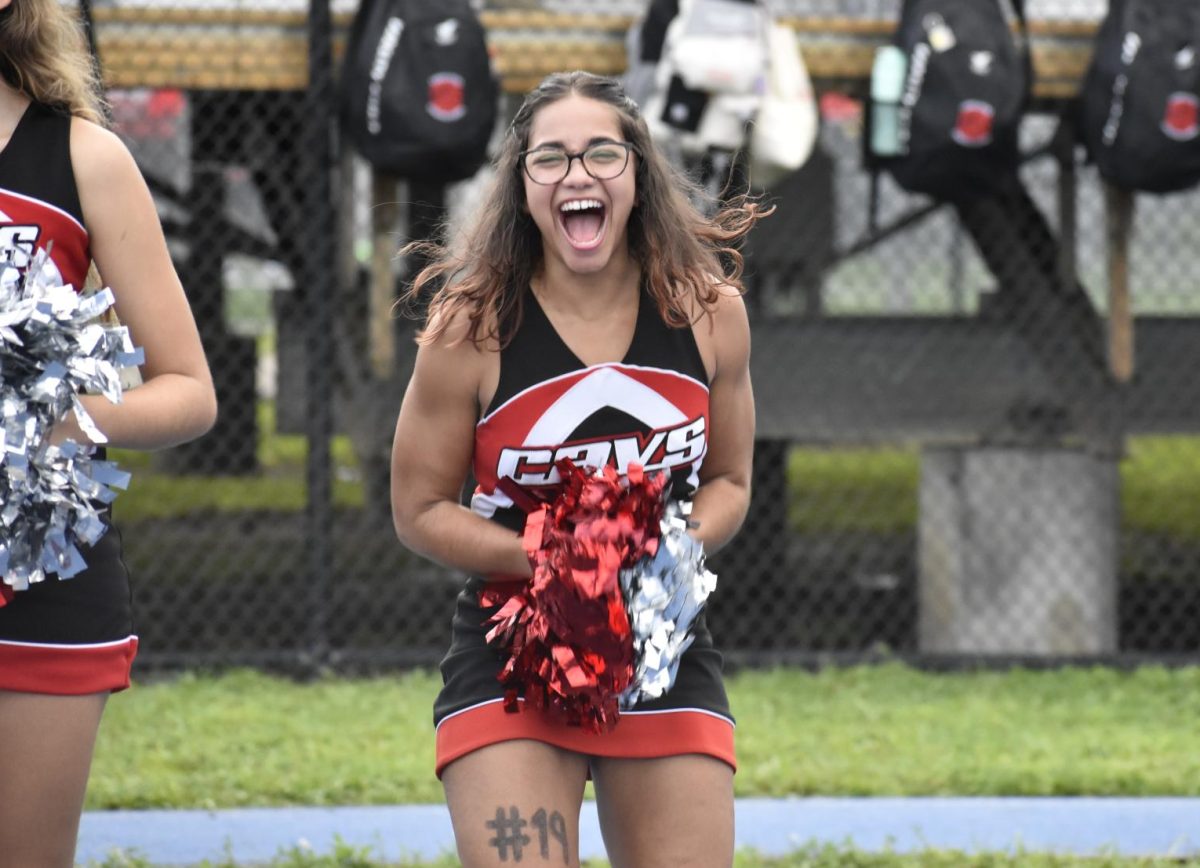 As Daly proudly stands on the side lines in her uniform, she excitingly cheers on the football players.