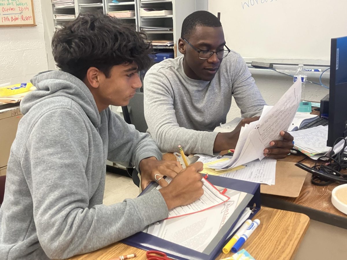 Mr. Constant explains the lesson of the day to his student during English 1. He is very involved and interactive with his students talking to them as equals.