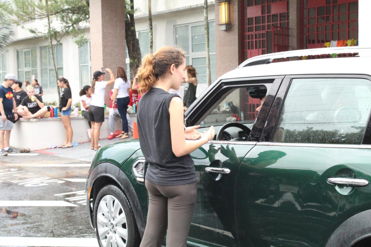Senior Laura Ridoux guides customer to the drying station.
