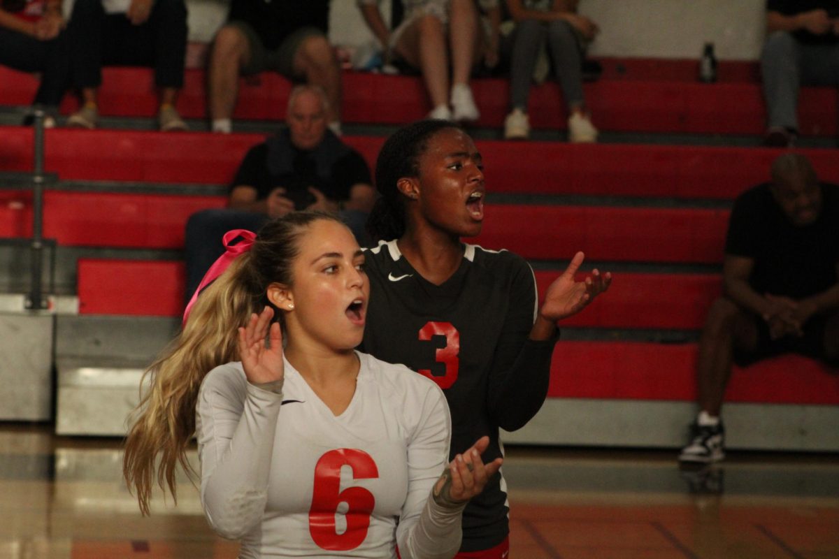 Noval (#6) claps after winning a point against the opposing team. Behind her is junior Celina Richardson who plays opposite hitter.