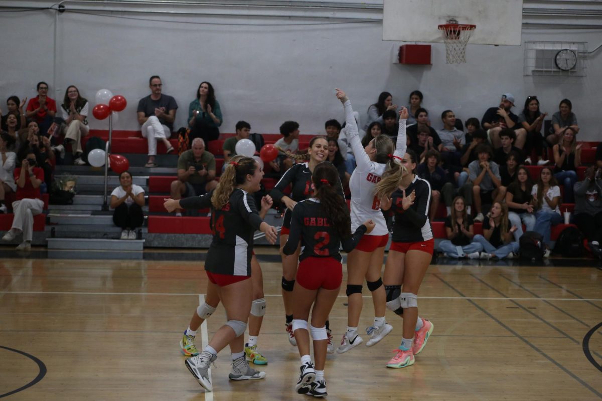 The varsity team celebrates their performance against the gators.