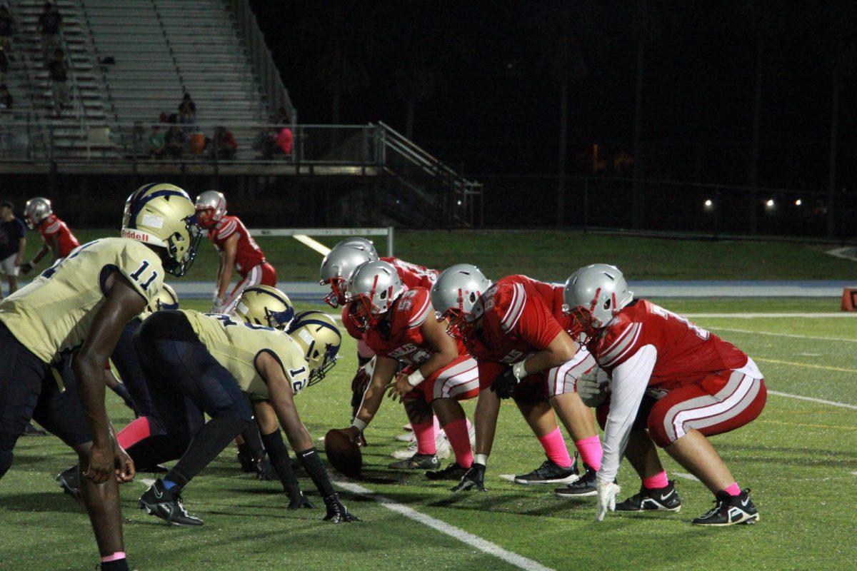 Posed in position, the Cavaliers prepare to run their routes as soon as the center throws back the football.