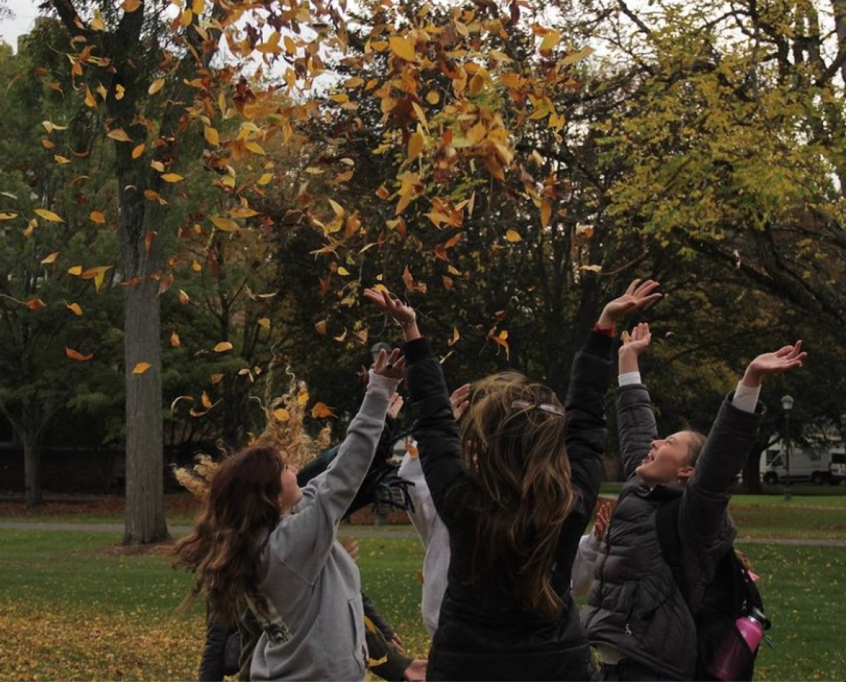 Students admire the fall colors of Hamilton University. 