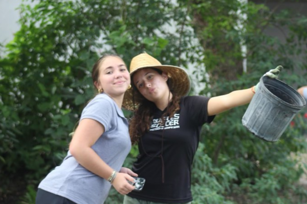 New club co-presidents, Olivia Russo (right) and Paz Chico (left) celebrate their first meeting of The Gables Garden Project as they clean up trash.