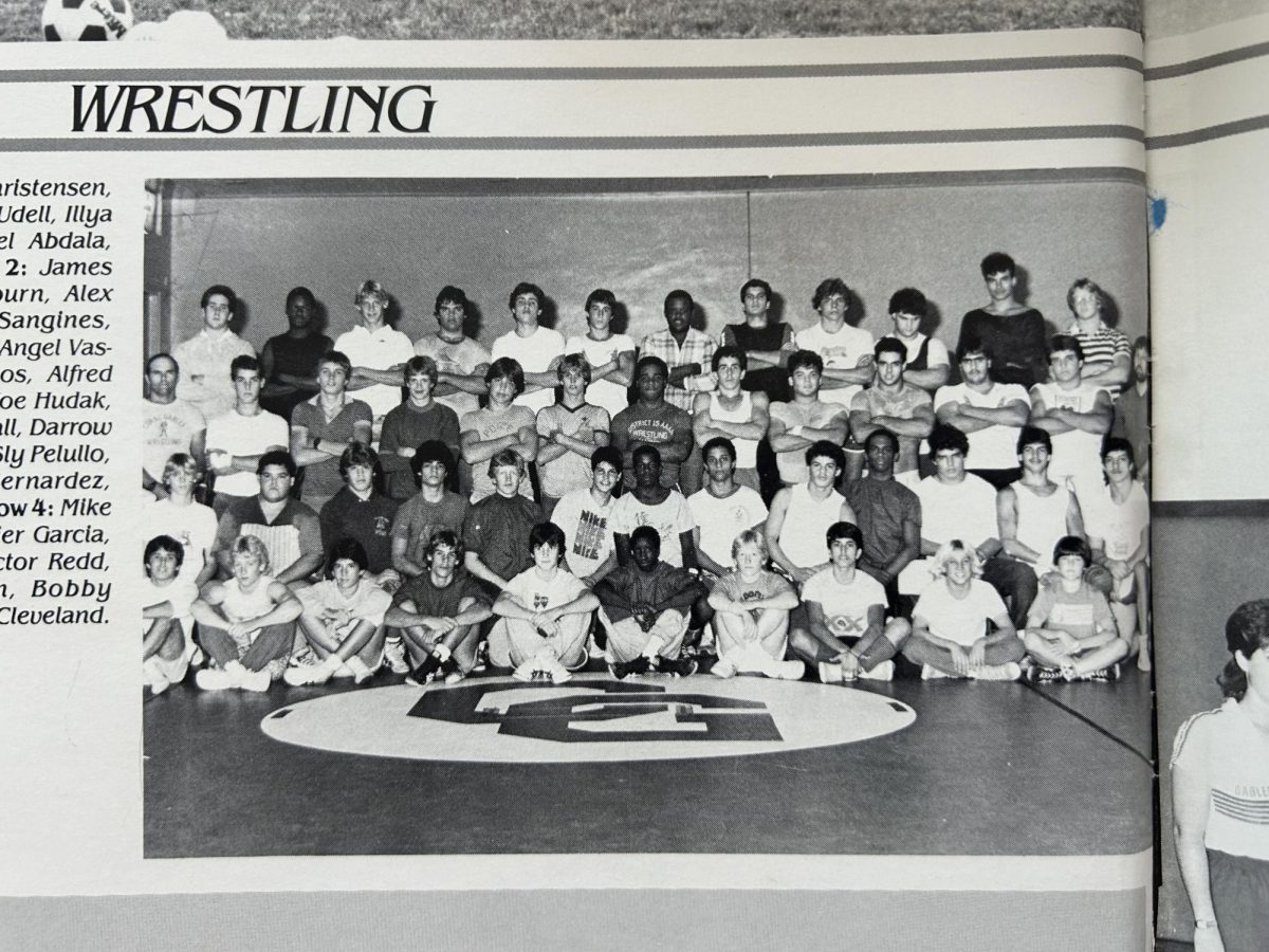 Davids (fourth, bottom row) sits beside Gables Wrestling Team, lead by coach Hudach. 