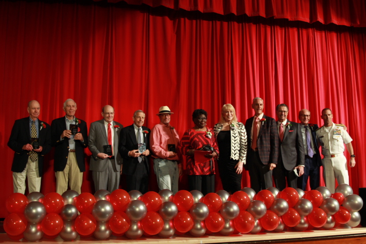 The 11 inductees stand with their plaques on the auditorium stage. Each one was recognized for their achievements and outstanding Cavalier spirit.