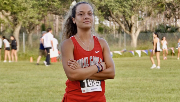 Senior Catalina Quinteros stands proudly at cross country regionals. She cherishes the moments that have brought her to her final races of the season. 
