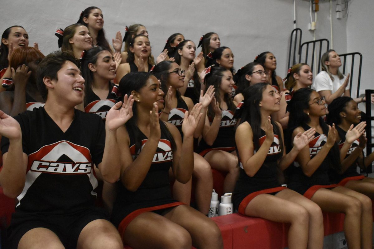 Cheerleaders clap in practiced unison to  support their players scoring on the court. With a final score of 78 to 32, the Cavaliers superseded expectations.