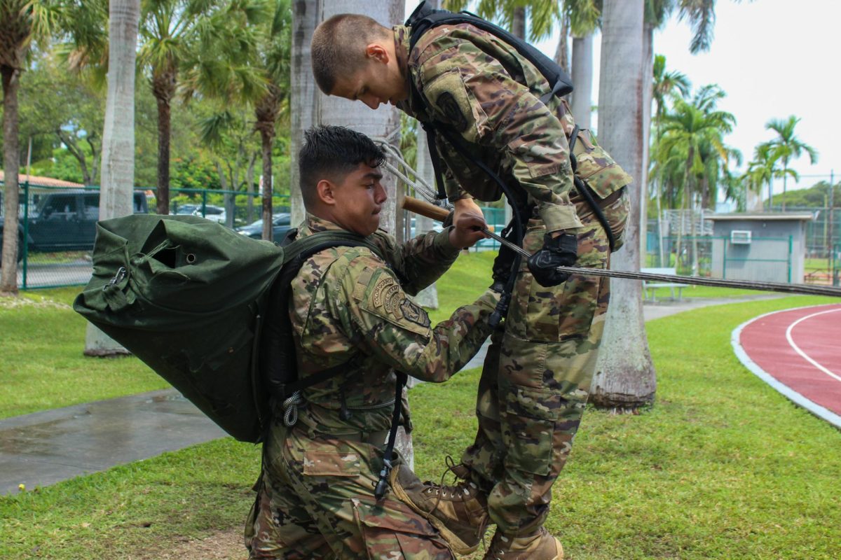 Cadet Captain Cabrera Jorton climbs up the cable to complete the next exercise.