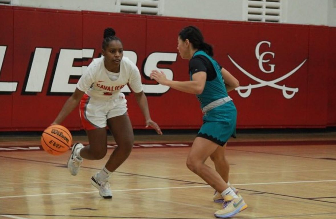 Dribbling down the court, senior Taylor Ravello picks a side to attack the Barracuda defense in the first home exhibition of the season. 