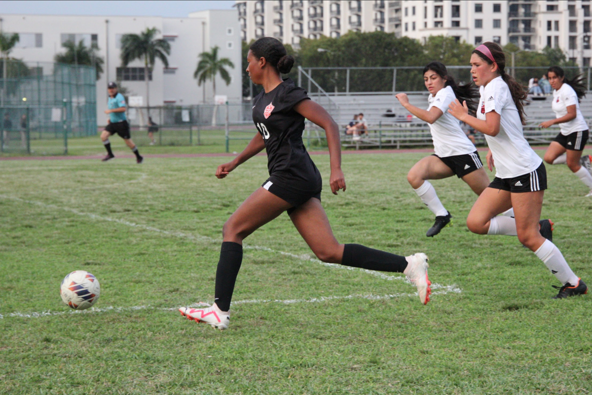 Freshman and future star Brooke Lawson passes the ball to her teammate while narrowly dodging the defense. 