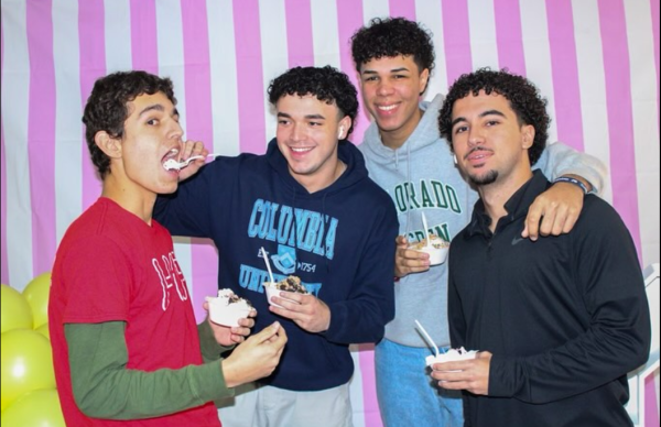 With their friends by their sides and ice creams in hand, Cavalier seniors pose at the photo booth in the decorative auditorium lobby. 