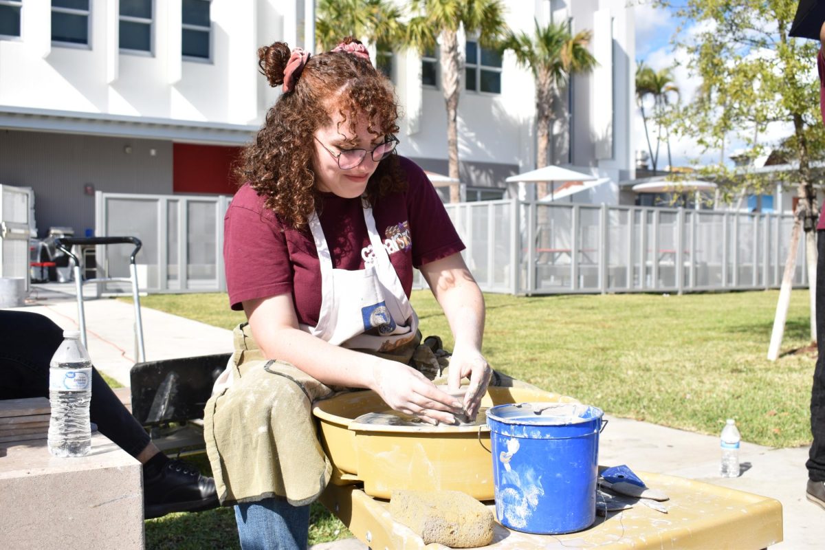 Senior, now Gables alumni Ale Toruellas finds pleasure in the masterpiece she is creating using a potters wheel and a variety of tools to assist her.