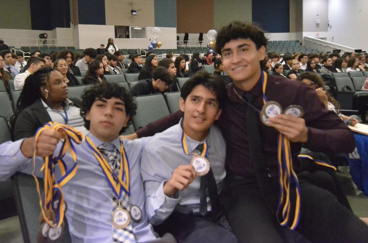 Members of FBLA proudly hold their medals up for a picture after winning a chance at states.