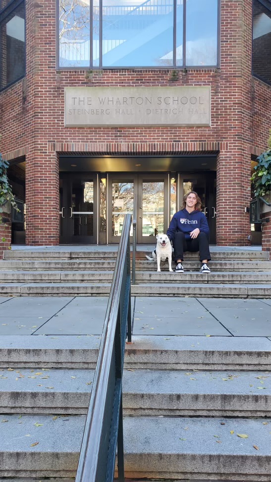 D'Allesio takes a picture with his dog at the Steinberg Hall.