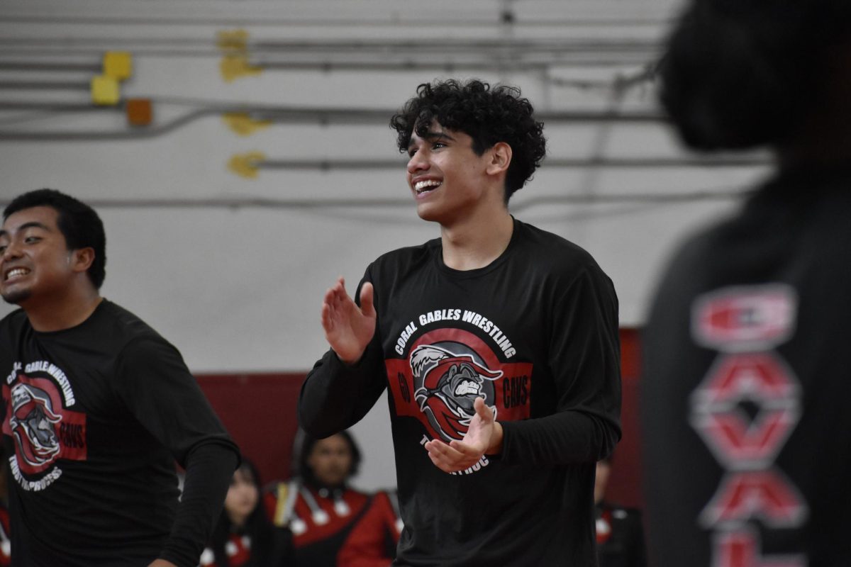 Proud captain, Wiliam Altamirano, cheers on his teammates at the annual Cavalier Wrestling scrimmage.