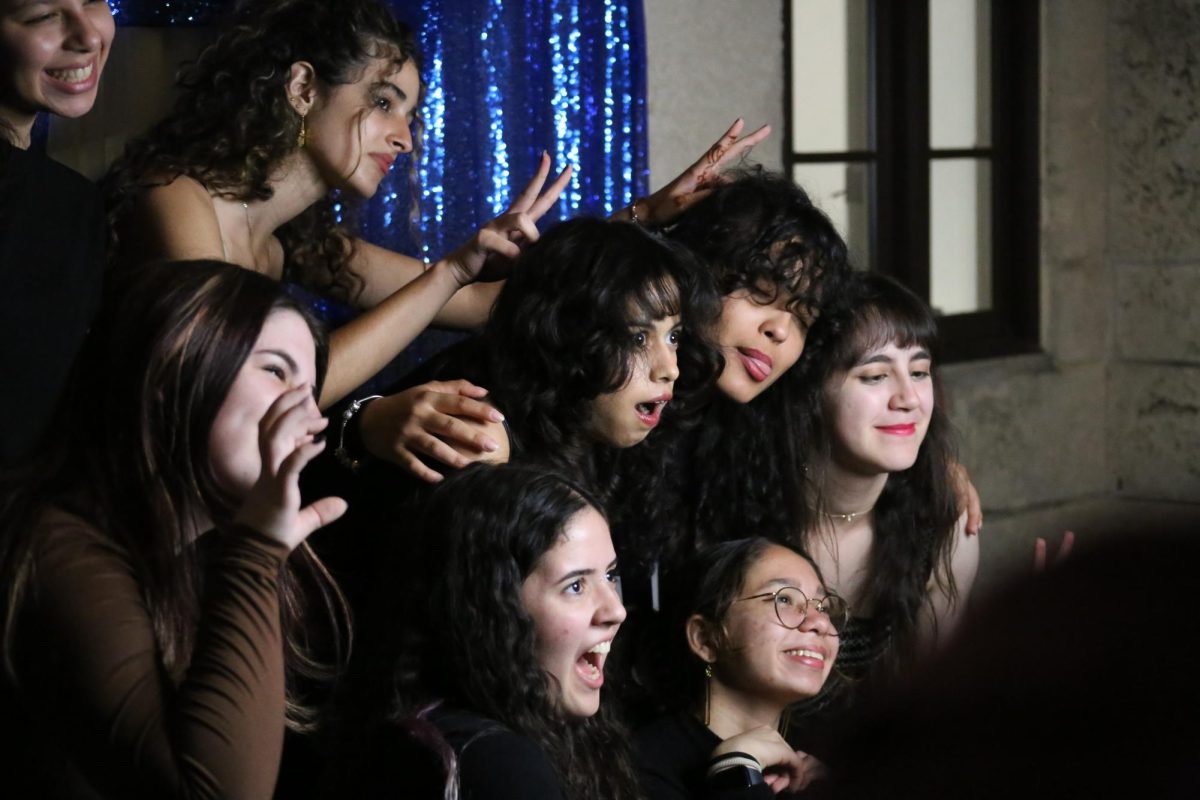 Making funny faces at the camera, these Cavaliers captured their memories of the evening at the photo booth by the entrance.