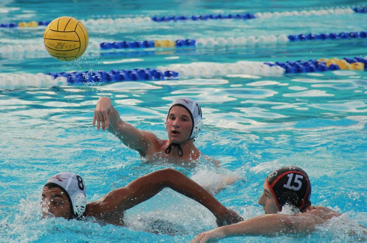 Junior Luca Verdi makes a wet pass to senior Ty Tyson traveling towards the center during the first game of the season against Miami Beach High.