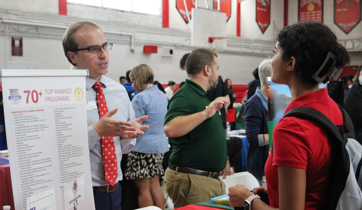 Senior Gloria Zaky speaks with 1 of 90 college representatives present during Gables' annual college fair.