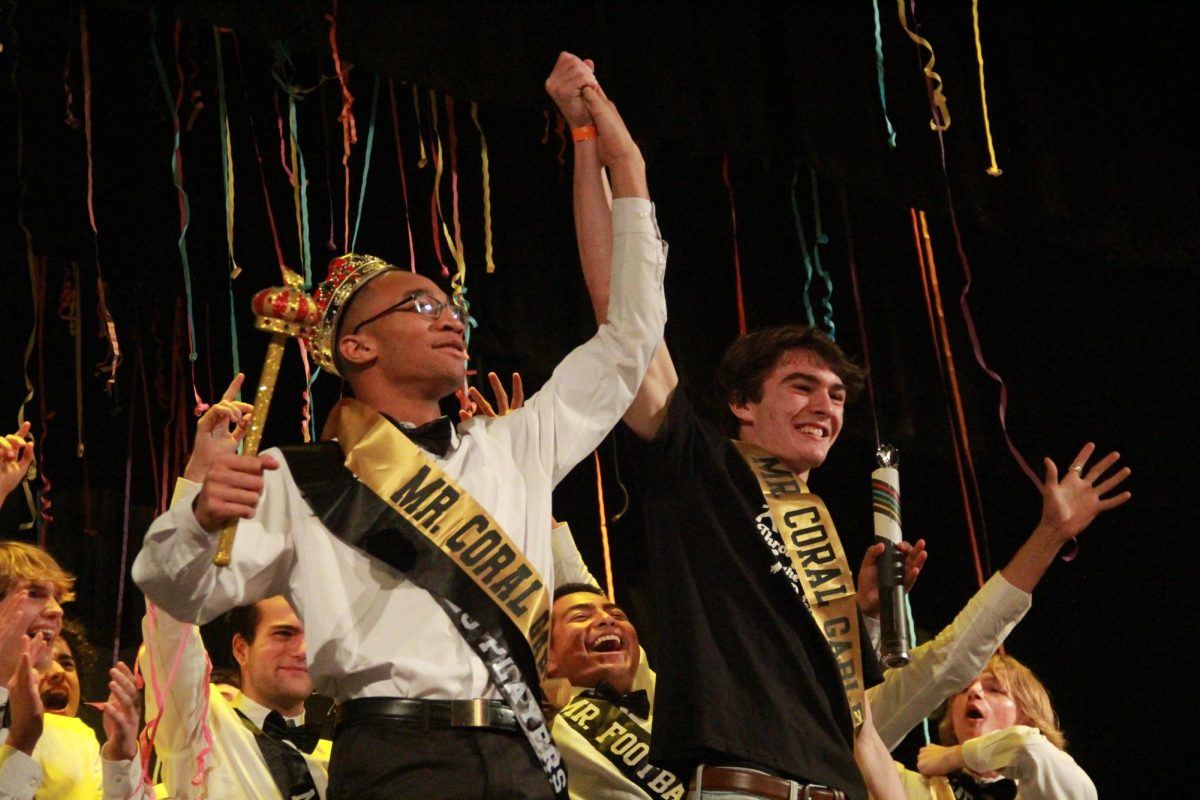 Announced by Gables alum and previous Mr. Coral Gables, Marcos Algeciras, Jamar *last name* is called to celebrate his victory as this year's Mr. Coral Gables.
