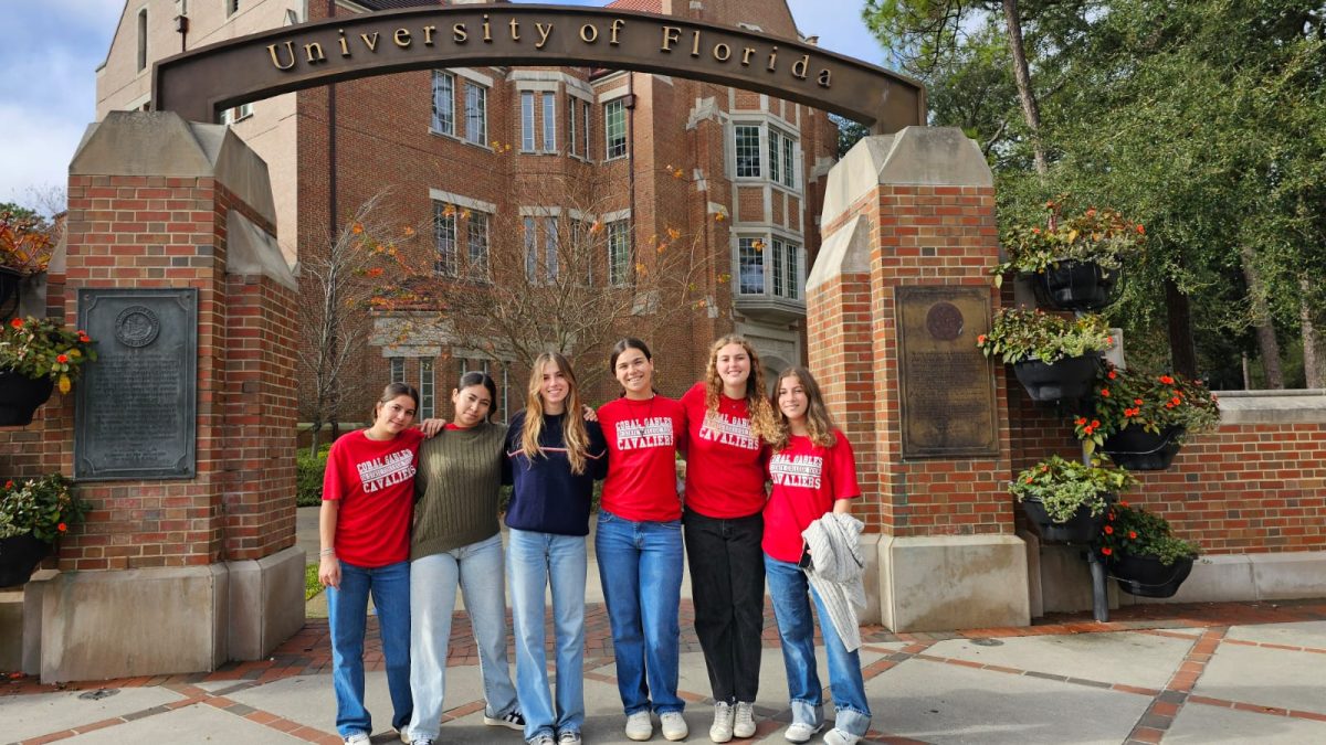 Concluding their tour, students pose and smile in front of the prestigious University of Florida to photograph their memories.