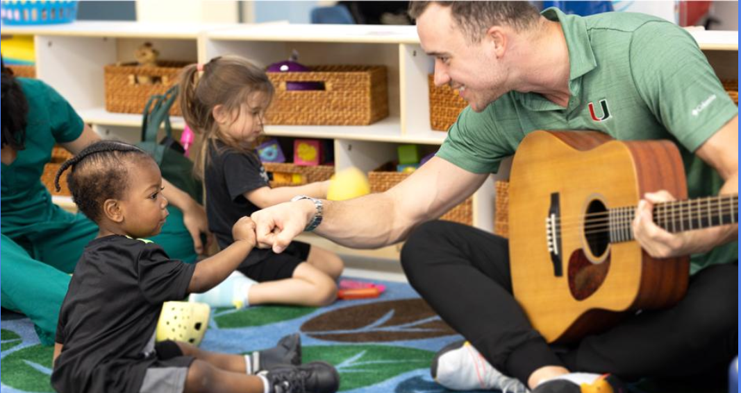 A staff member at the Linda Ray Intervention Center teaches the children about music. He aspires to help them with their social and emotional development.