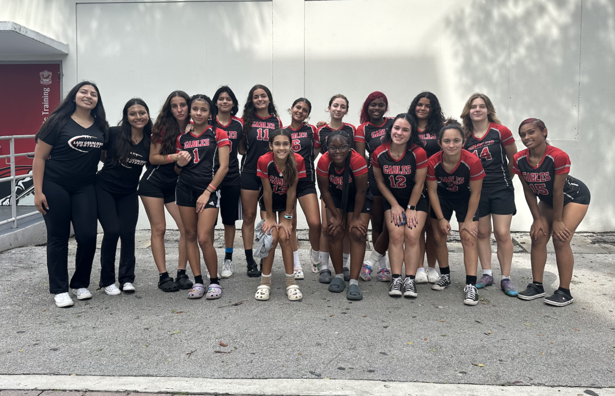 The girls flag football team takes a photo to showcase their new additions for the 2023-2024 season.