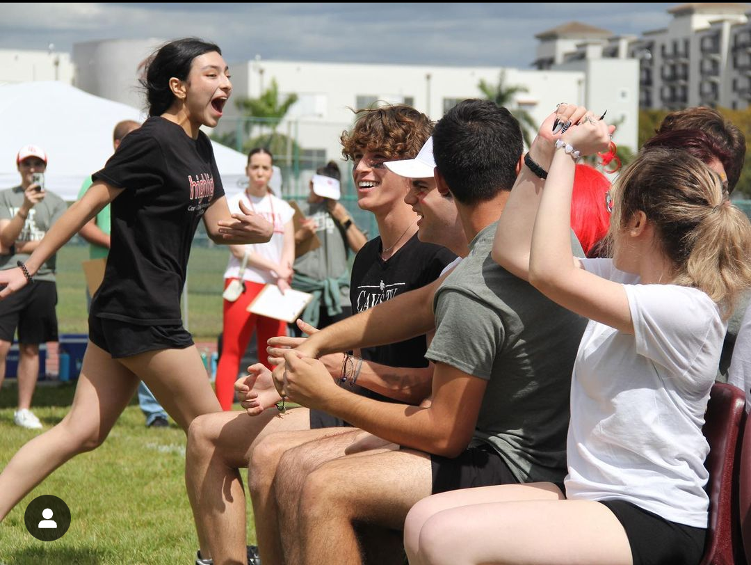 With a round of musical chairs, cavaliers began field day with a competitive energy about. Those seated cheer loudly at their success, while a member of Highlights leaves the pool of competitors. 