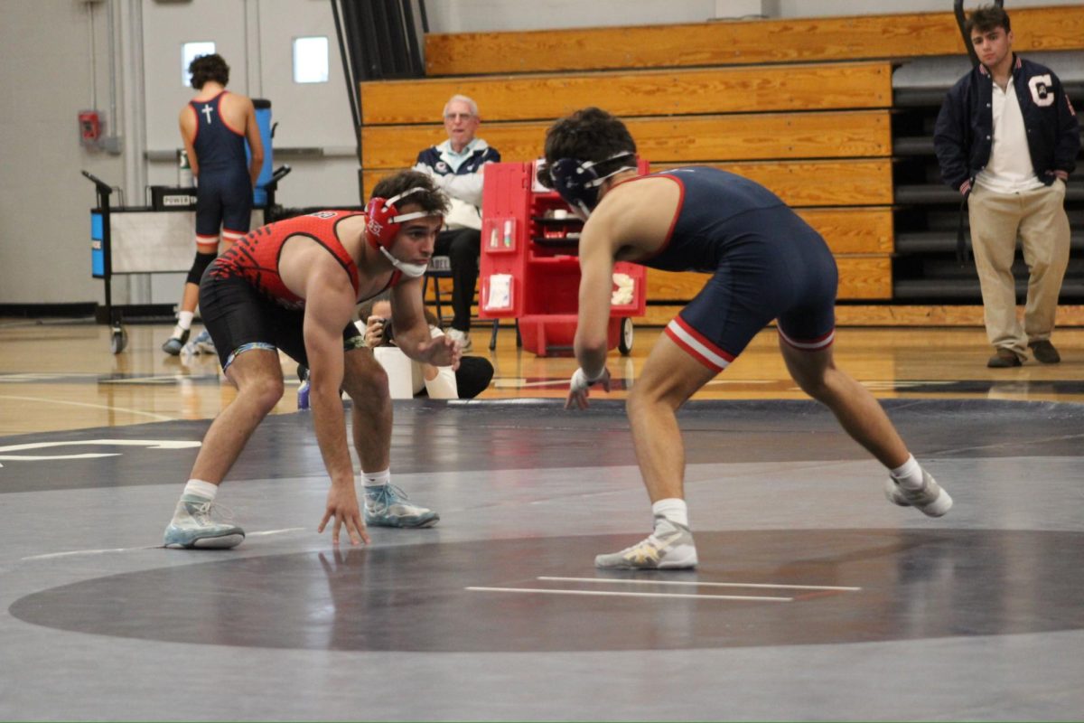 Stepping on to the mat for one last time,  Imbert has led Gables to qualify for the state championship. Getting into his stance, he prepares to wrestle his opponent.