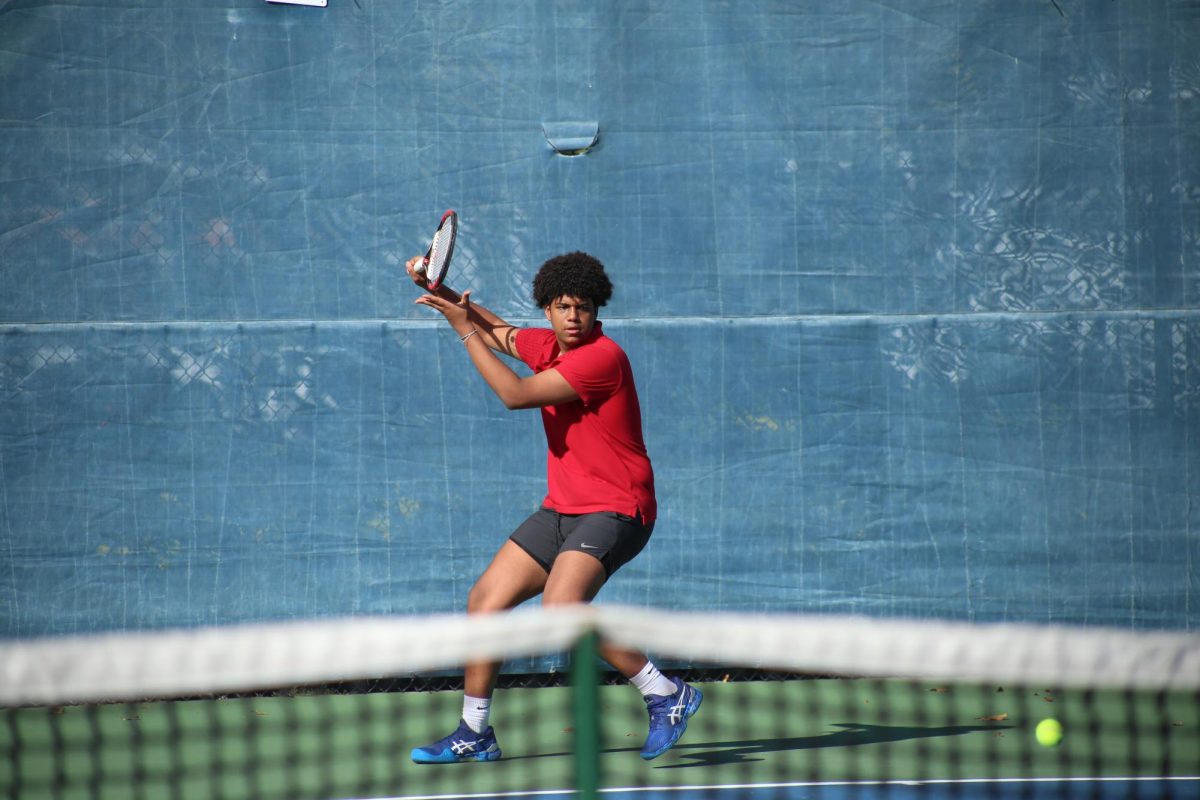 Senior Jaden Solomon prepares to propel the ball as it is returned from the Riviera team. 