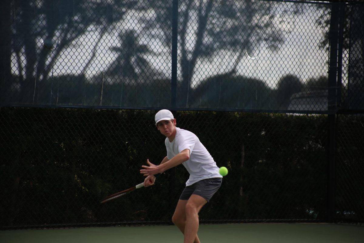 Freshman Byrne Corbin retracts his arm backward as the ball flies towards him to keep a rally going. 