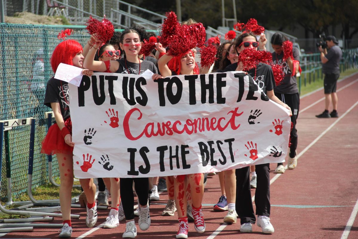 Chanting "put us to the test, Cavsconnect is the best." Cavaliers march on the field with their prideful banners. 