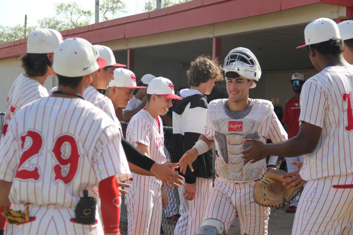The+Gables+baseball+team+hypes+each+other+up+before+their+game.+Each+player+received+high+fives+on+their+way+to+their+starting+position.+
