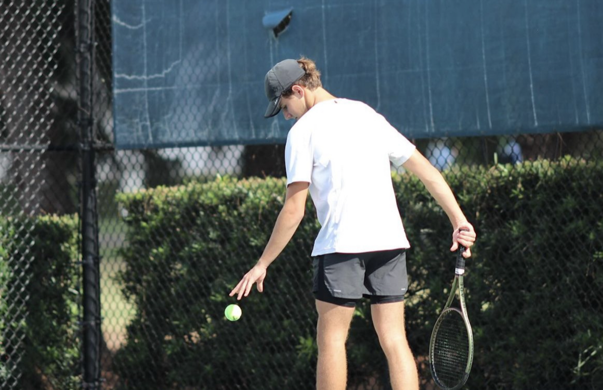 Freshman+Ricardo+Watson+prepares+to+serve+in+his+singles+match+against+South+Dade.+Watson+played+as+number+one+player+and+won+6+to+0.