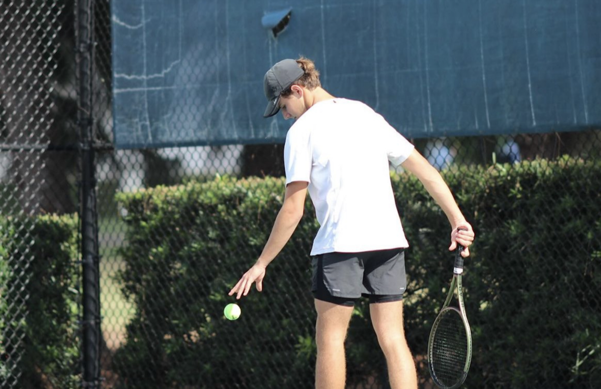 Freshman Ricardo Watson prepares to serve in his singles match against South Dade. Watson played as number one player and won 6 to 0.