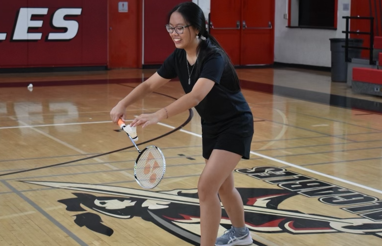 Tiffany Beh prepares to serve the shuttlecock as she plays badminton on the gables court.