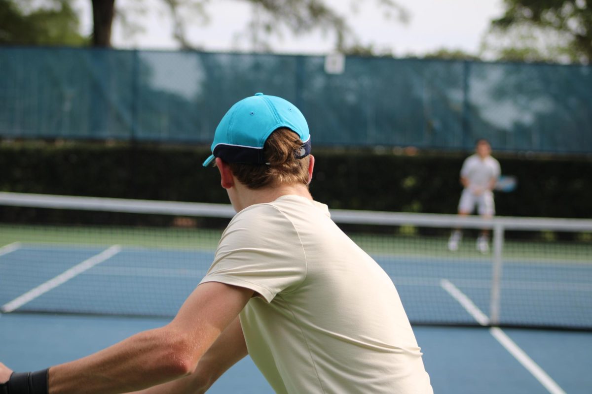Freshman Byrne Corbin assumes the position of an offensive player as he serves the ball. 