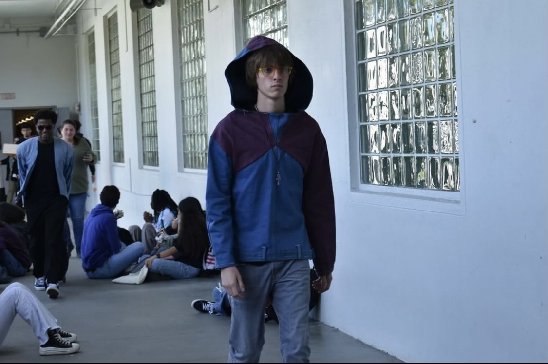 A student wears a clothing piece made by Hugot and puts on a showcase around the school during both lunches.