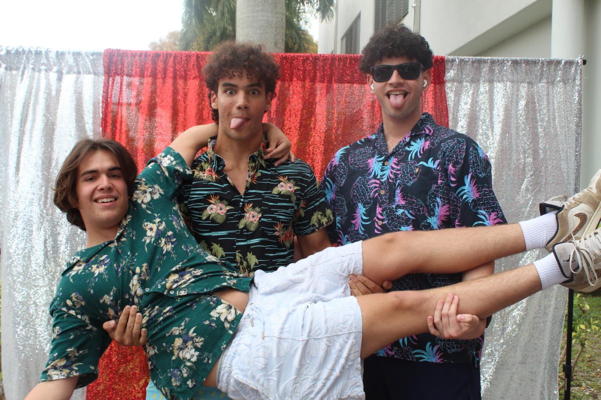 Seniors Antonio Rodrigues, Mauricio Quesada and Roberto Sosa show their Cavalier pride by dressing up for their last "Twin Day".