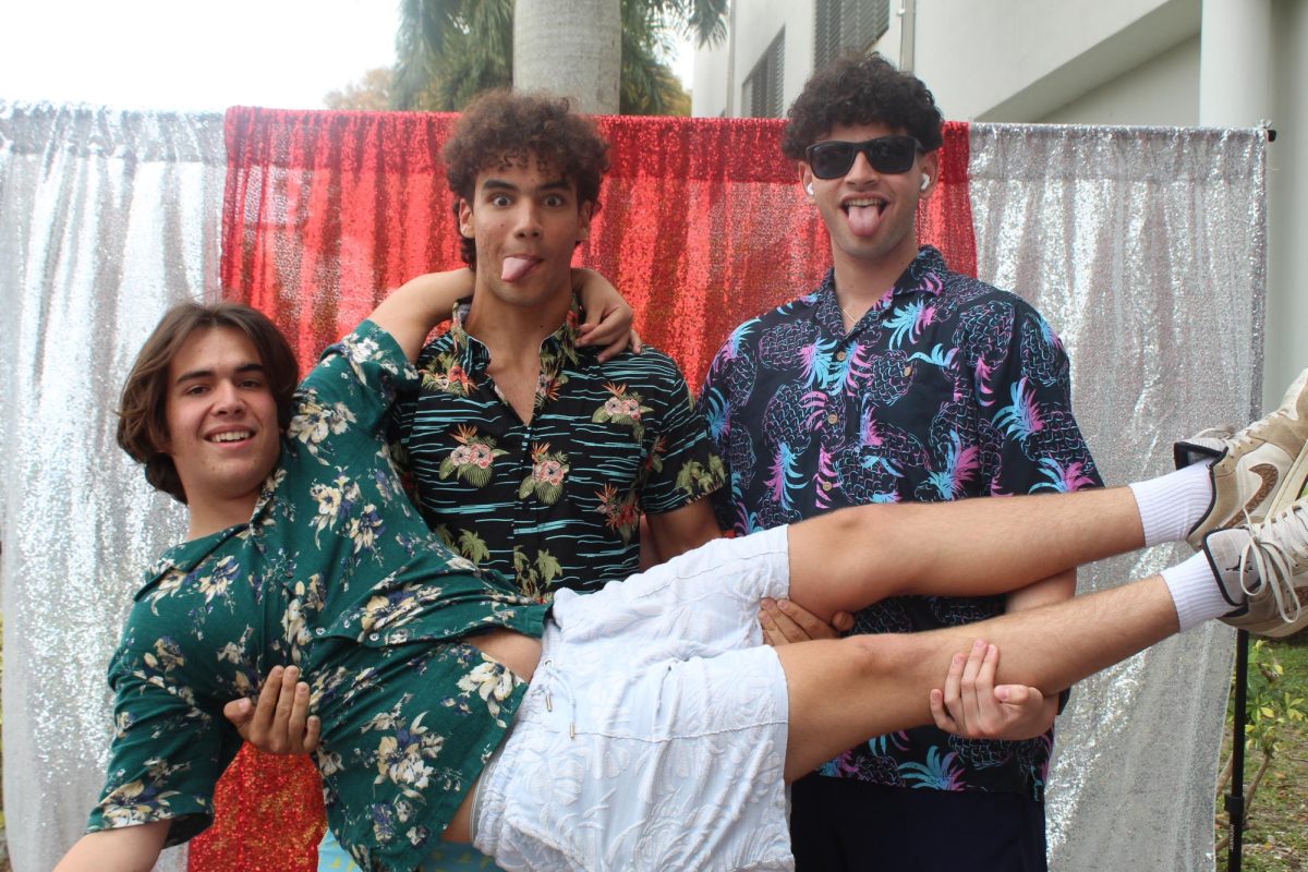 Seniors Antonio Rodrigues, Mauricio Quesada and Roberto Sosa show their Cavalier pride by dressing up for their last Twin Day.