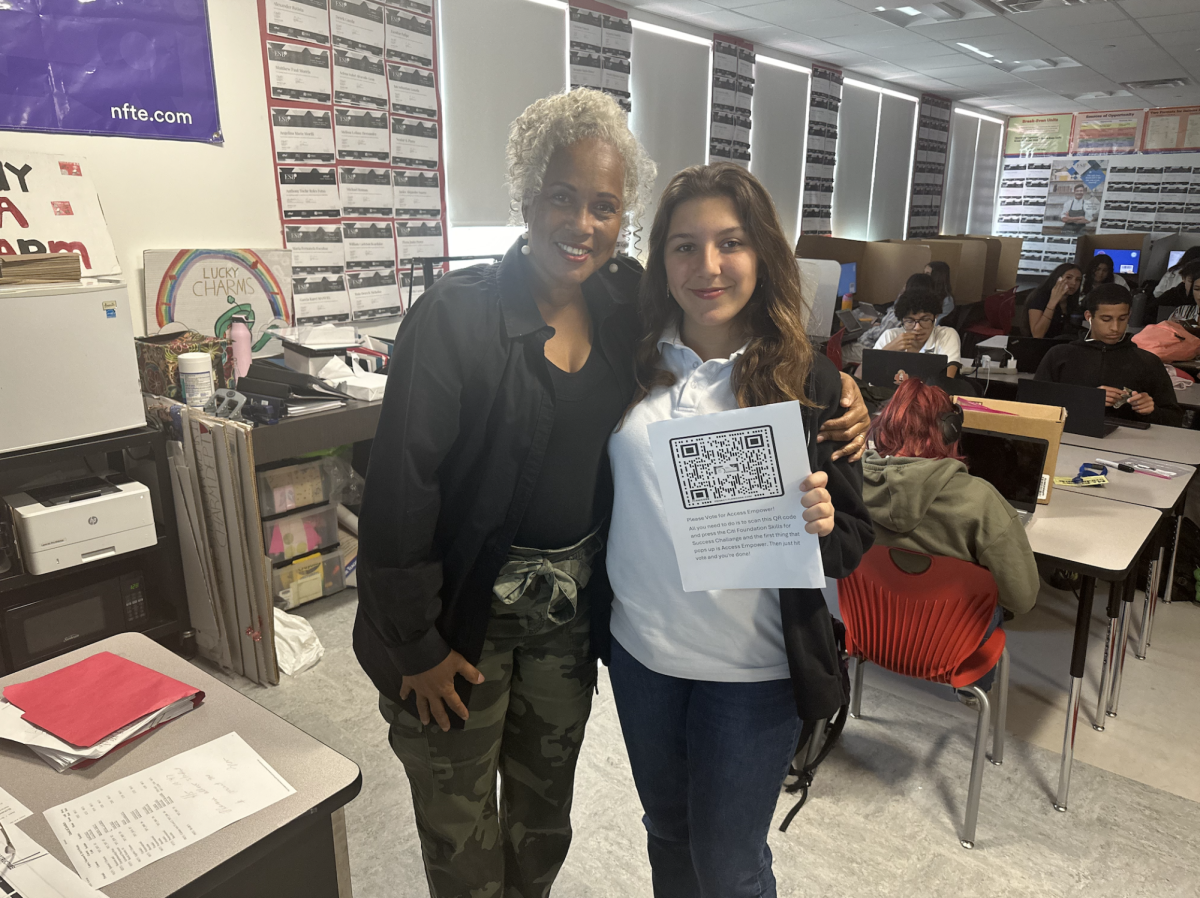 Victoria Fuller and her mentor, Ms. Brown, posed as Fuller showed her finished entry to the NFTE Challenge.