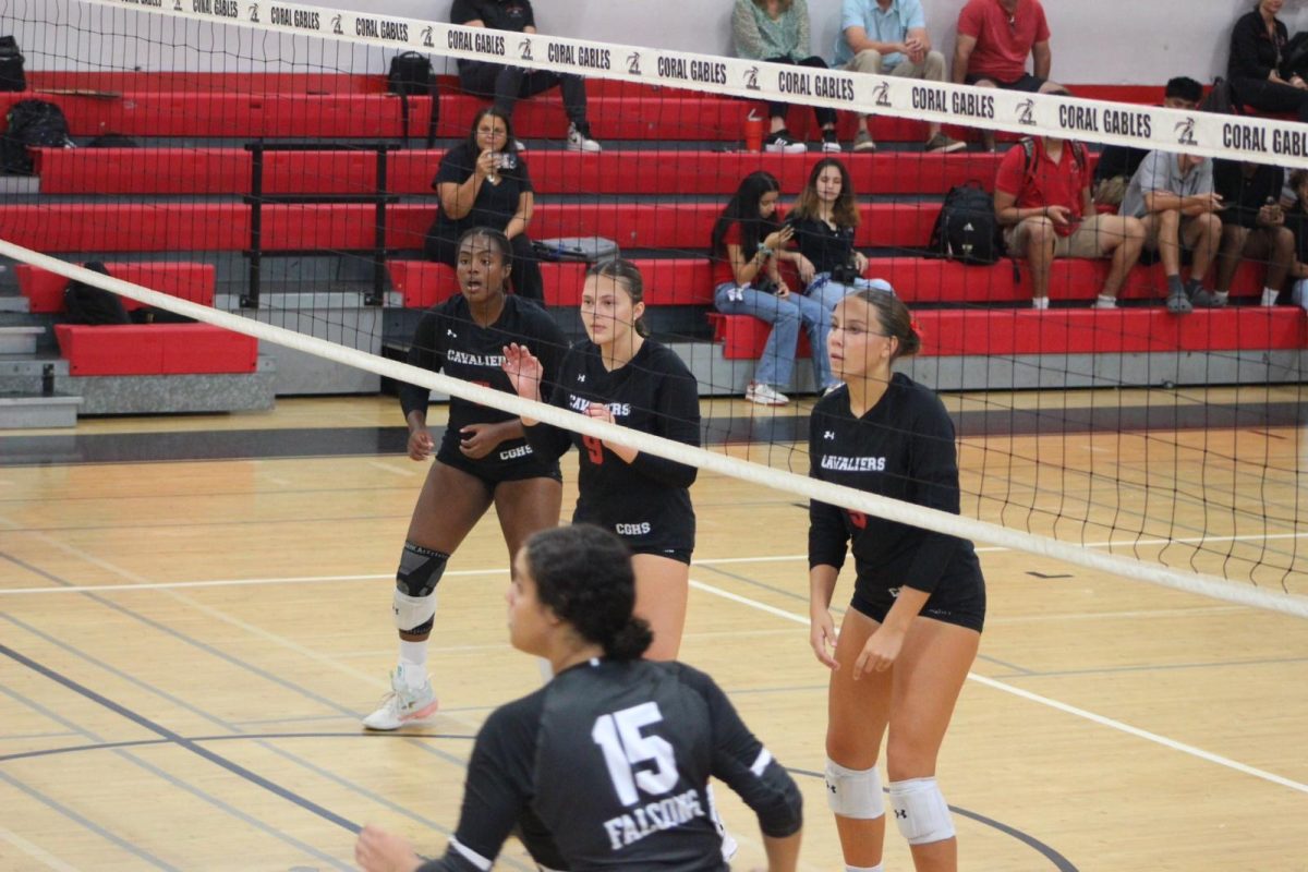 Seniors Celina Richardson, Andrea Winkeljohn, and junior Bianca Benson work together to secure a point for Gables.