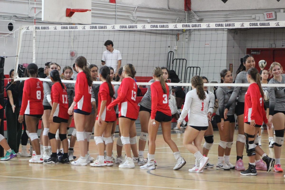 Our Lady Cavaliers show great sportsmanship with their opponents, the Ferguson Falcons.